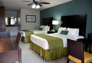 2 queen beds, Table, Desk, Dresser with TV and mini-fridge.