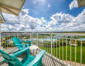 Sunny balcony view w/ chairs.