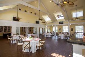 Windmill event space set for a formal reception with specialty linens and chivari chairs.