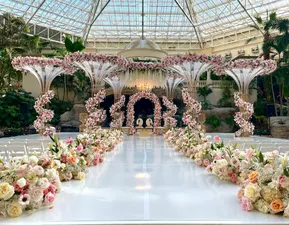 Wedding at Emerald Bay Plaza – A breathtaking indoor oasis featuring tropical landscaping, refined décor, and a romantic ceremony setting protected from the elements.
