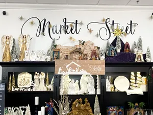 Photo of a display of Nativities and Angels, with the words "Market Street" painted on the wall above