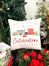 Photo of a decorative throw pillow with the phrase "There's no place like Celebration at Christmas"