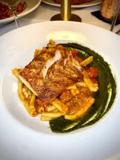 Our wood fire grilled salmon is served over a bed of fresh pasta