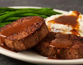 A Guy Fieri favorite on Diners, Drive-Ins and Dives! Griddle-seared meatloaf with rich brown gravy, creamy mashed potatoes and steamed green beans.