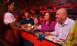 Server with family and their meals during the show.