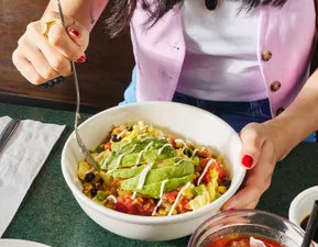 Southwest Scramble Bowl - available all day - Avocado, bacon, scrambled eggs, and roasted grape tomatoes, served over hashbrowns and drizzled with Hollandaise sauce.