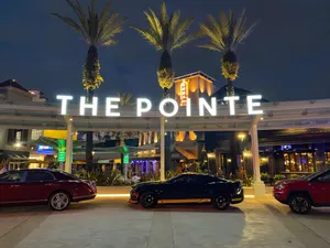Night time photo of the valet area and sign at The Pointe