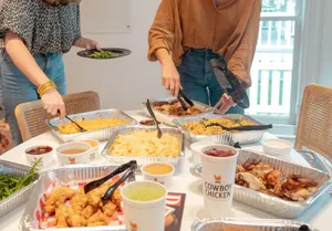 Family serving Cowboy Chicken at their home or vacation rental.