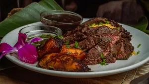 10oz Chairman's Reserve skirt steak, homemade chimichurri sauce served with yellow rice, Cuban style black beans & maduros