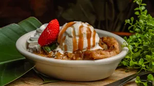 A gourmet pie of baked cinnamon, apple, walnuts & custard, served hot with fresh vanilla bean whipped cream and ice cream.