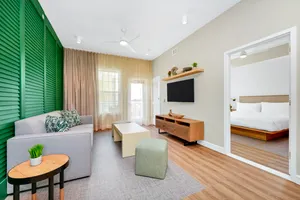 The living room is separated from the bedroom by a privacy door. Enjoy a free made-to-order breakfast and Evening Reception featuring beer, wine, premium spirits, and light snacks. Includes WiFi, a sofa bed, microwave, refrigerator and two 55-inch HDTVs as well as a hairdryer, in-room safe, iron and coffeemaker.