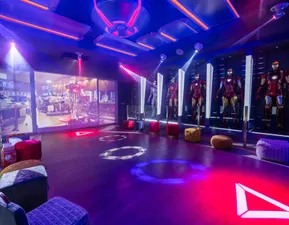 Experience an epic ultra-themed entertainment room with immersive lighting and larger-than-life superhero vibes at Magical Vacation Homes in Reunion Resort.
