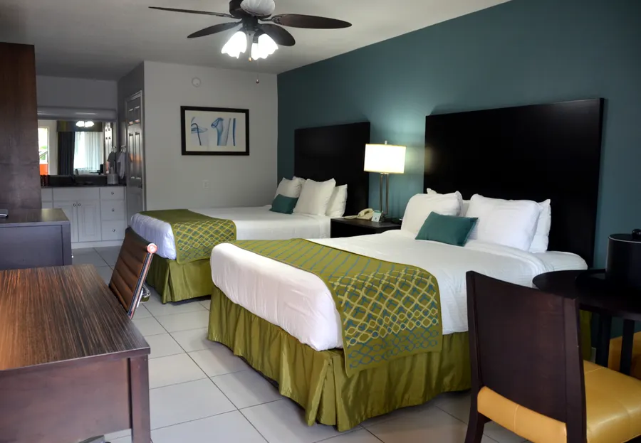 2 queen beds, Table, Desk, Dresser with TV and mini-fridge.