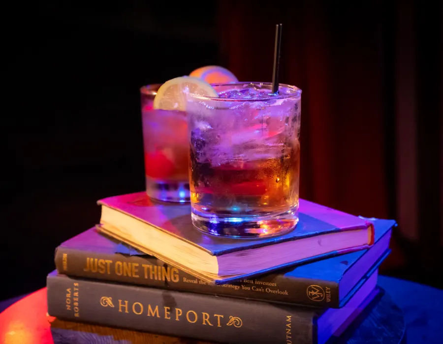 Picture of an Old Fashioned on top of a pile of books.
