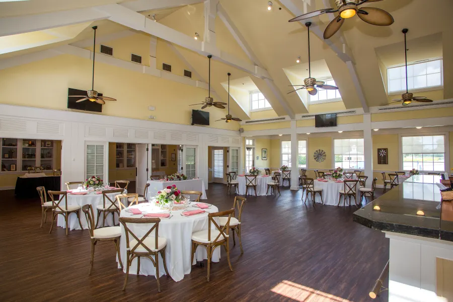 Windmill event space set for a formal reception with specialty linens and chivari chairs.