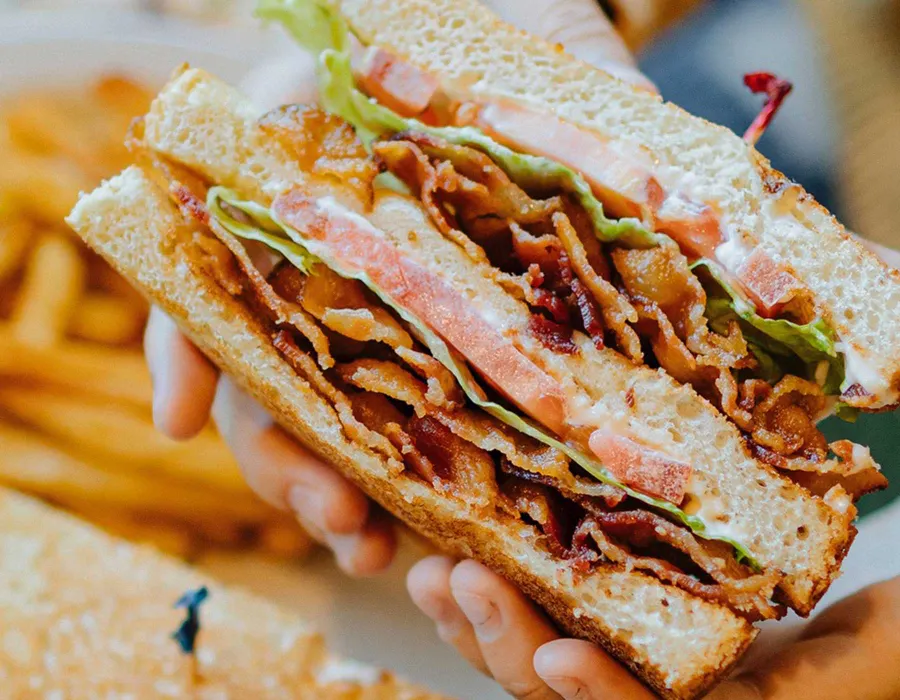 Three slices of toast, loaded with bacon, lettuce, tomato and mayo.