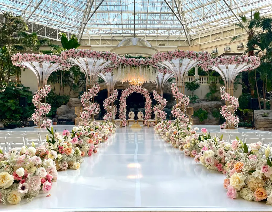 Wedding at Emerald Bay Plaza – A breathtaking indoor oasis featuring tropical landscaping, refined décor, and a romantic ceremony setting protected from the elements.