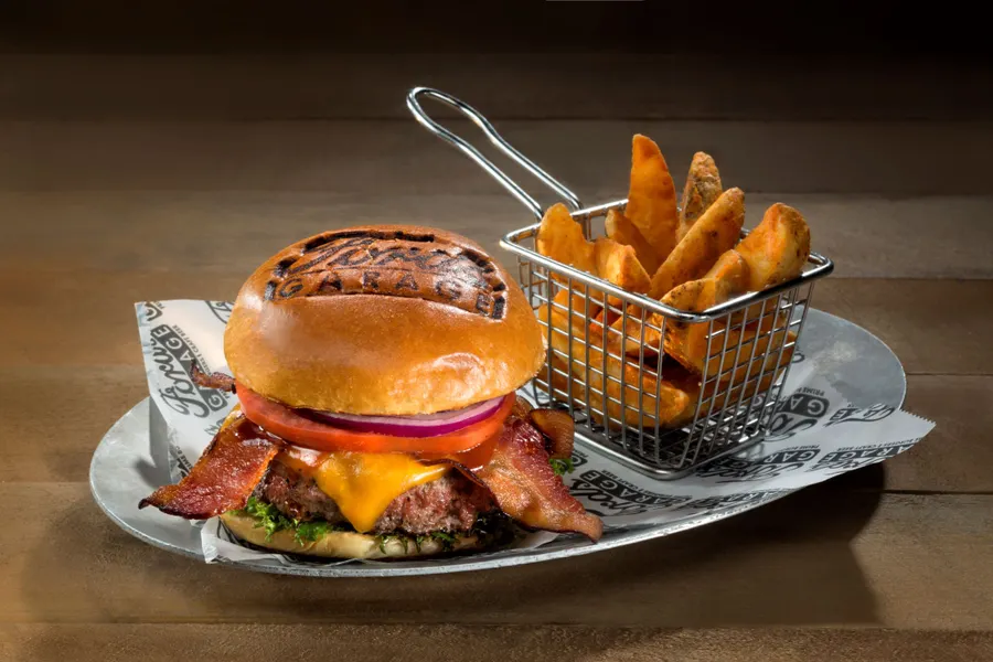 Half Pound of Grilled Black Angus, Aged Sharp Cheddar Cheese, Applewood Smoked Bacon, Bourbon BBQ Sauce, Lettuce, Tomato, and Red Onion on a Brioche Bun