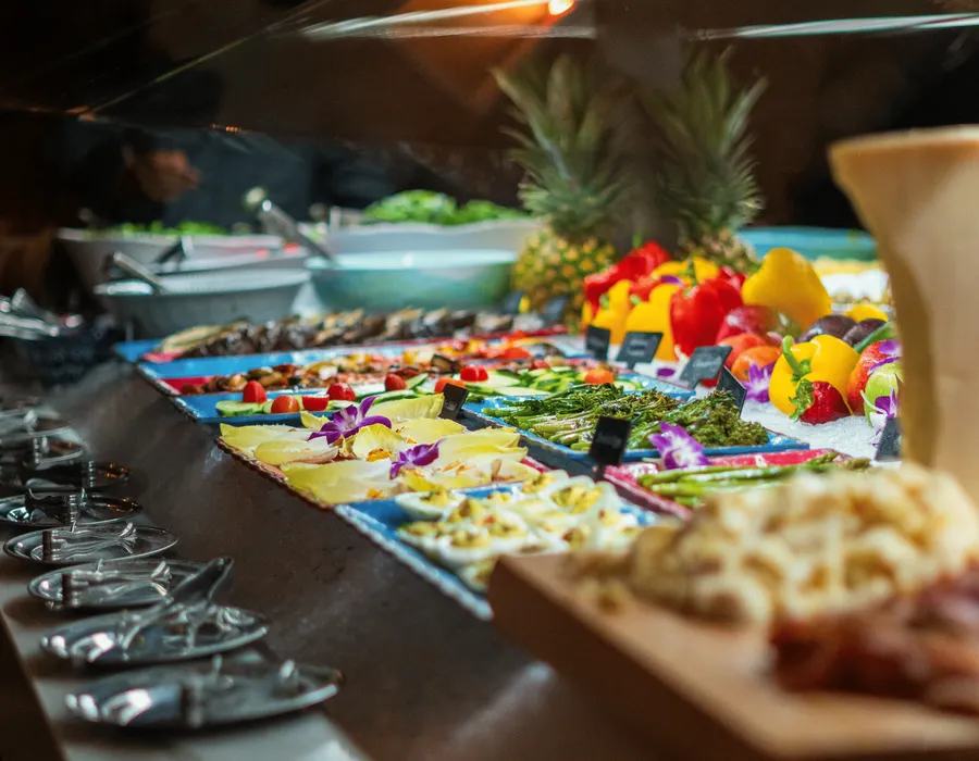 Discover why Adega Gaucha Brazilian Steakhouse stands out among the best salad bar restaurants near me. Our Gourmet Table goes beyond any salad bar, crafted for those healthy cravings. Enjoy a curated selection of 50+ signature salads, charcuterie, hot dishes, fresh fruits, vegetables, and more. Perfect for Wednesday lunch specials near me, good lunch places near me, group dining, dinner, or a weekend brunch filled with fresh greens, salads, and veggies.