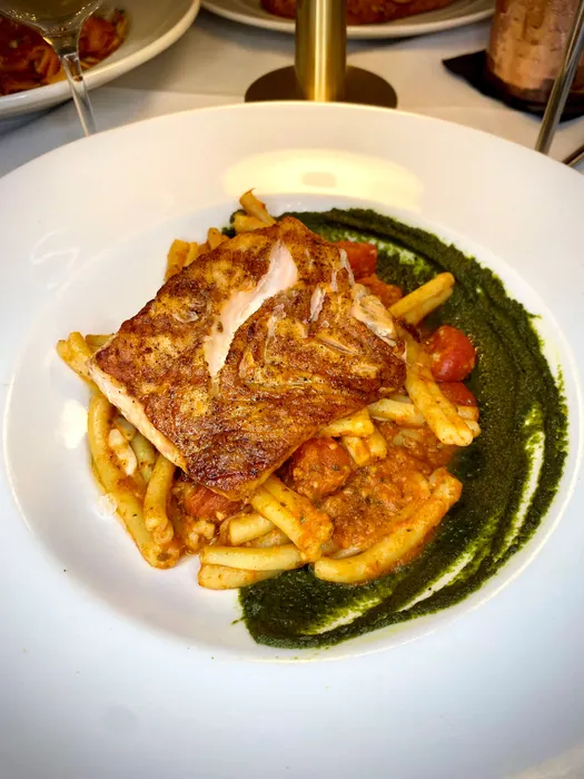 Our wood fire grilled salmon is served over a bed of fresh pasta