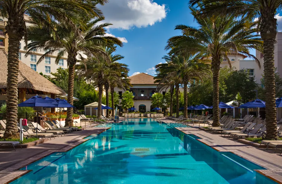 South Beach Pool at Gaylord Palms offers a laid-back escape with a spacious zero-entry design, palm-lined surroundings, and plenty of room to relax or splash. Perfect for families and guests looking to unwind under the Florida sun.