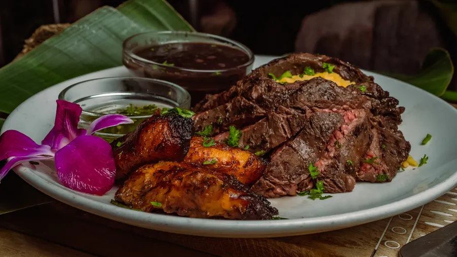 10oz Chairman's Reserve skirt steak, homemade chimichurri sauce served with yellow rice, Cuban style black beans & maduros