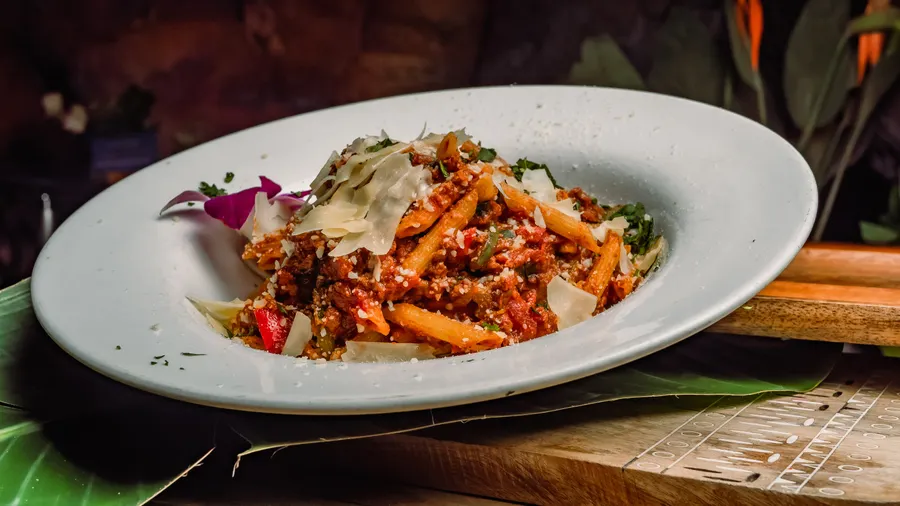 Plant based Impossible Bolognese sauce, wild vegetables & shaved parmesan