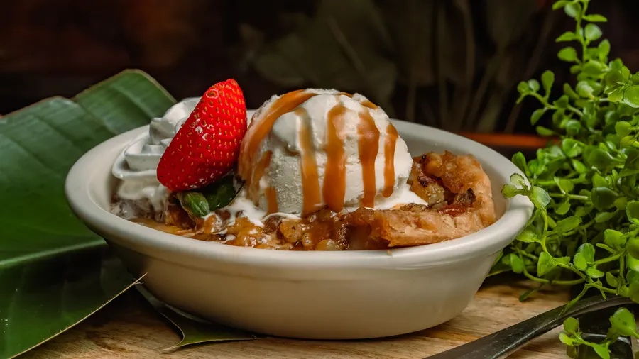 A gourmet pie of baked cinnamon, apple, walnuts & custard, served hot with fresh vanilla bean whipped cream and ice cream.