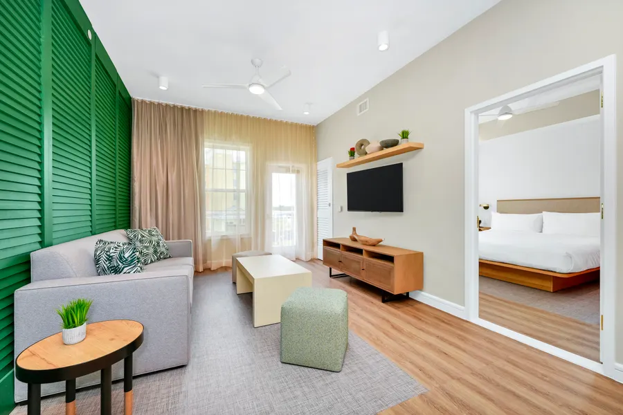 The living room is separated from the bedroom by a privacy door. Enjoy a free made-to-order breakfast and Evening Reception featuring beer, wine, premium spirits, and light snacks. Includes WiFi, a sofa bed, microwave, refrigerator and two 55-inch HDTVs as well as a hairdryer, in-room safe, iron and coffeemaker.