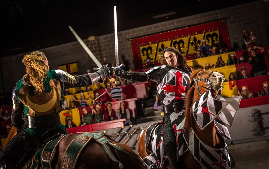 sword fight on horseback between the black and white knight and the green knight