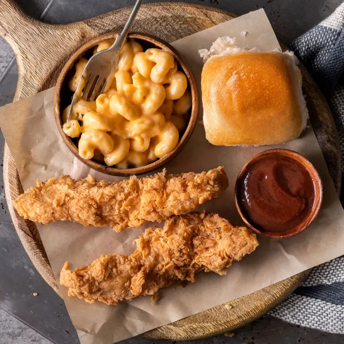 Cowboy Chicken Kids Meal Tenders with Mac n Cheese, roll and dipping sauce.